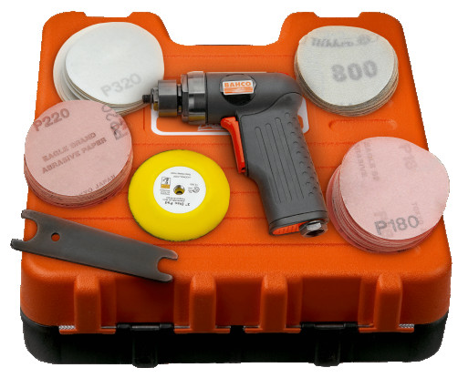 A grinder with a pistol grip and a set of discs